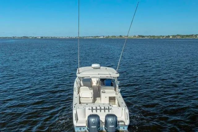  Yacht Photos Pics 2017 Grady-White Freedom 307 boat on open water, rear view with dual engines.