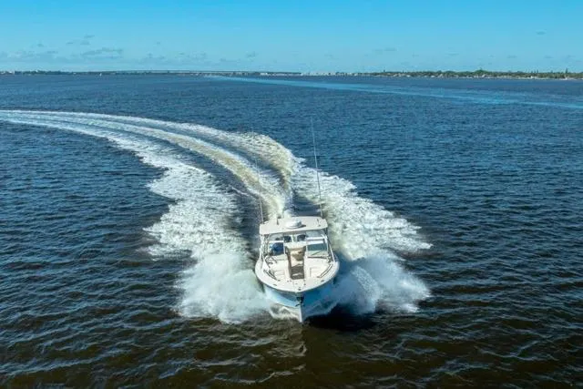  Yacht Photos Pics 2017 Grady-White Freedom 307 boat cruising on open water under clear blue skies.