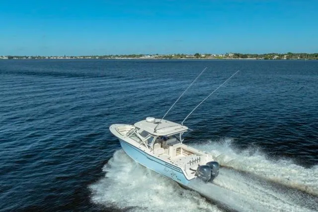  Yacht Photos Pics 2017 Grady-White Freedom 307 boat cruising on open water under clear blue skies.