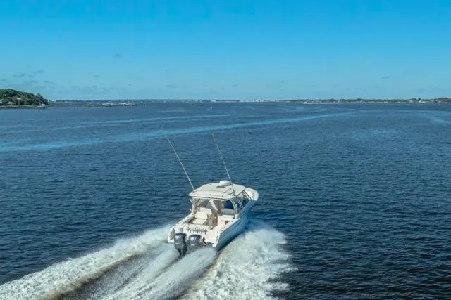  Yacht Photos Pics 2017 Grady-White Freedom 307 cruising on open water under clear blue skies.