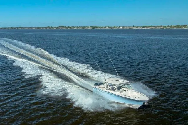  Yacht Photos Pics 2017 Grady-White Freedom 307 boat cruising on open water under clear blue skies.