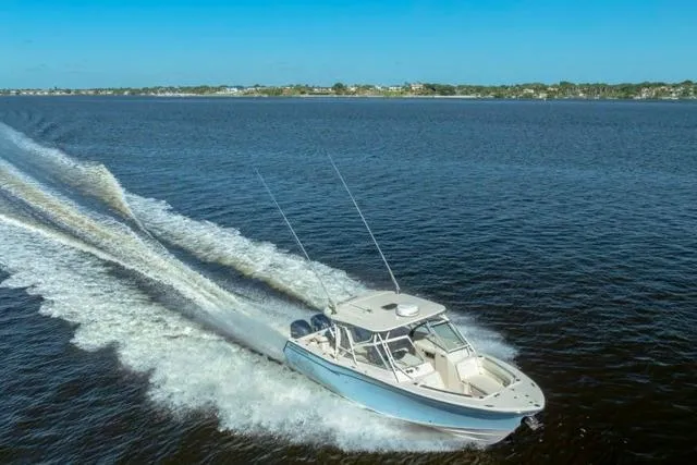  Yacht Photos Pics 2017 Grady-White Freedom 307 boat cruising on open water under clear blue skies.