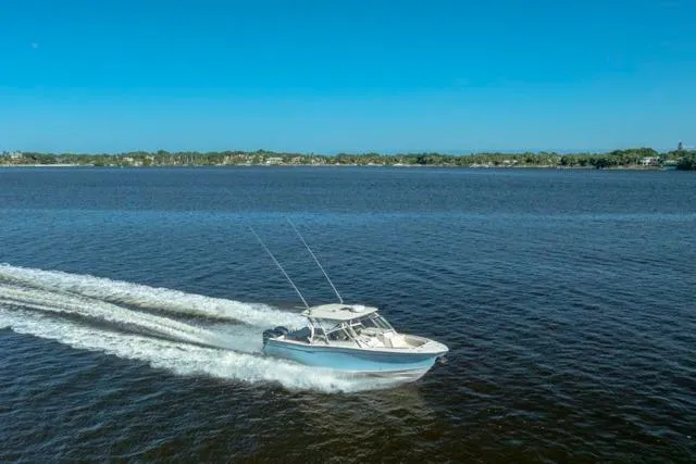  Yacht Photos Pics 2017 Grady-White Freedom 307 boat cruising on a calm blue lake.