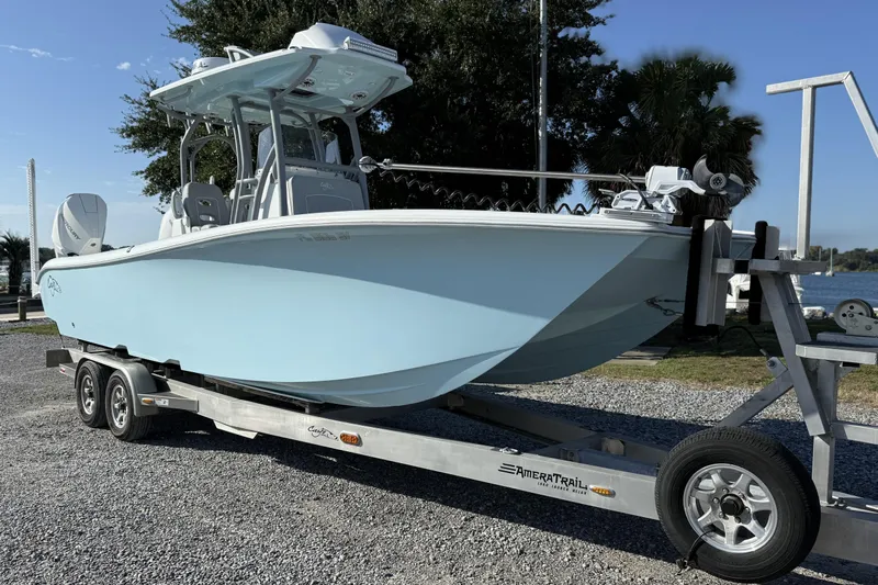  Yacht Photos Pics 2021 Costa Custom Boats 264 HC on trailer, light blue hull, parked near water.