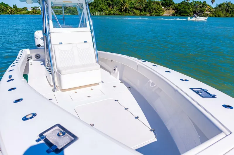  Yacht Photos Pics 2022 Conch 27 boat on clear blue water, featuring sleek design and spacious deck.