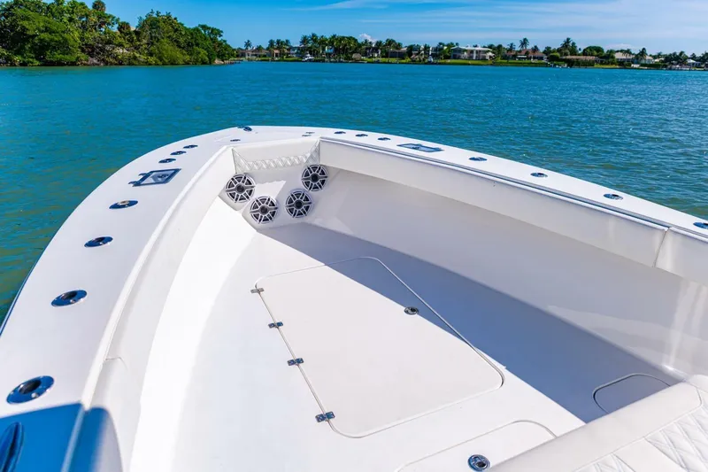  Yacht Photos Pics 2022 Conch 27 boat on calm water, featuring spacious deck and modern design.