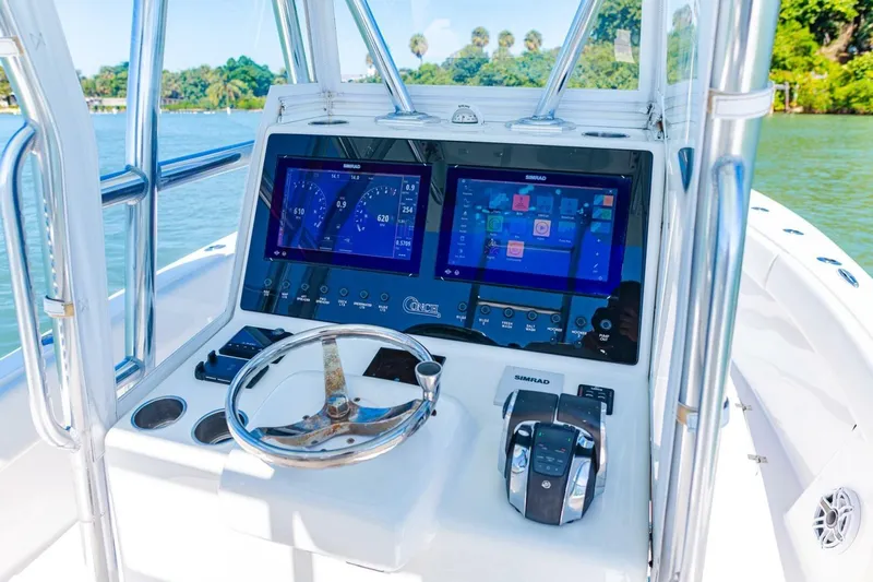  Yacht Photos Pics 2022 Conch 27 boat dashboard with dual Simrad displays and steering wheel.