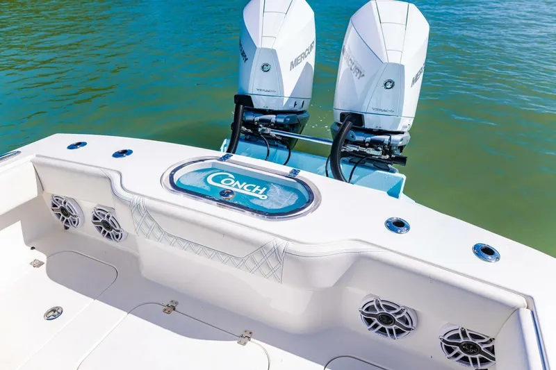  Yacht Photos Pics 2022 Conch 27 boat with dual Mercury engines on calm water.