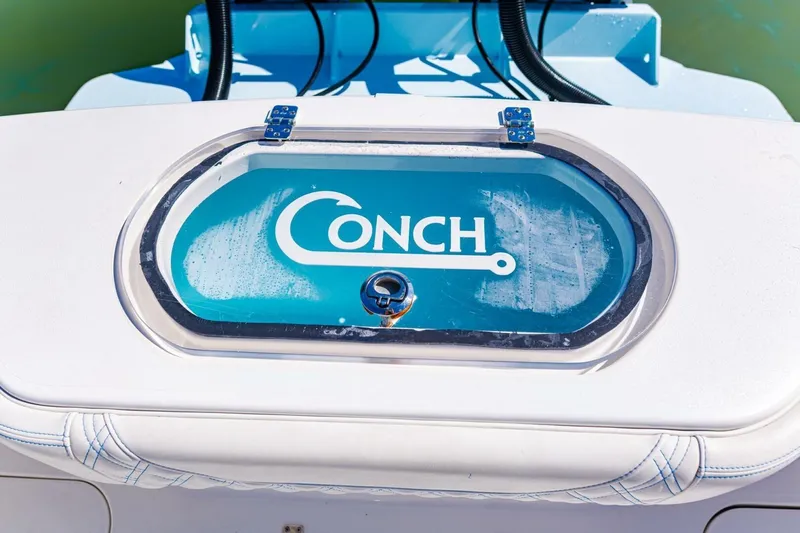  Yacht Photos Pics 2022 Conch 27 boat livewell with logo, featuring sleek design and blue accents.