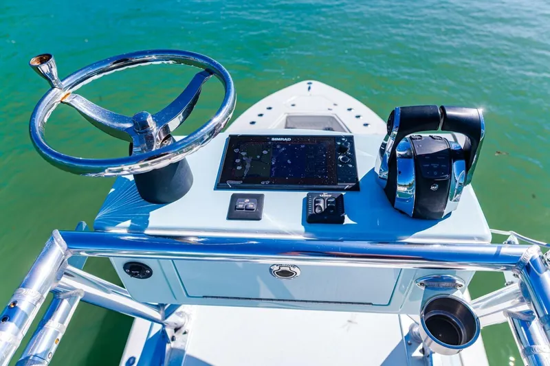  Yacht Photos Pics Control panel of 2022 Conch 27 boat with steering wheel and navigation system.