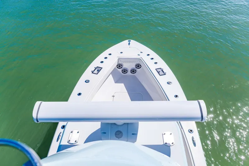  Yacht Photos Pics Bow view of 2022 Conch 27 boat on clear green water.