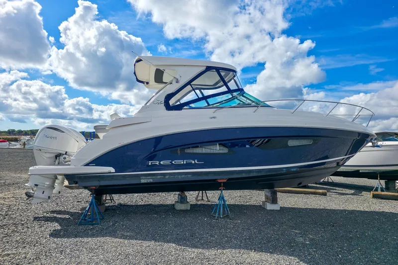  Yacht Photos Pics 2026 Regal 33 XO boat on stands under a bright blue sky.