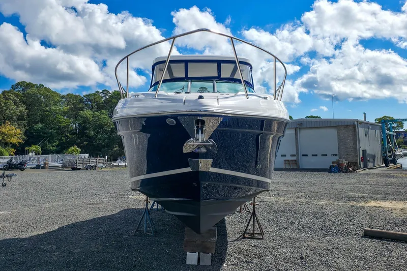  Yacht Photos Pics 2026 Regal 33 XO boat on dry dock under a bright blue sky.