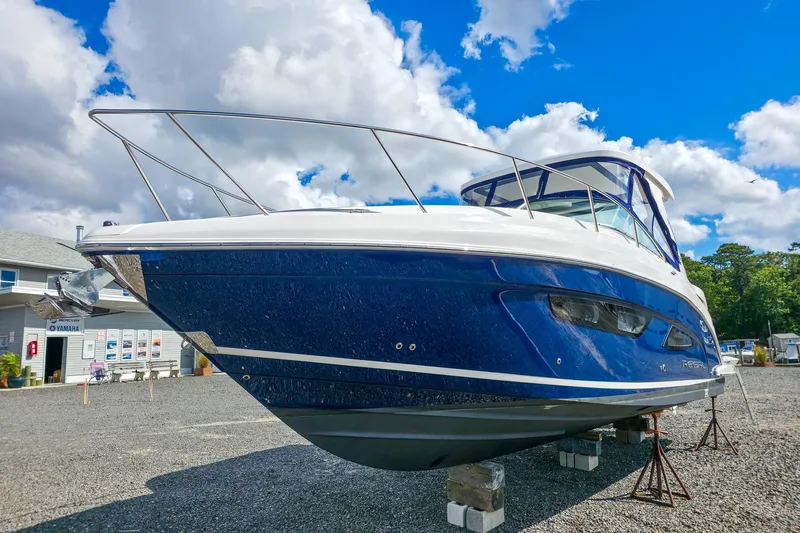  Yacht Photos Pics 2026 Regal 33 XO boat on display under a bright blue sky.