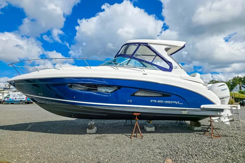  Yacht Photos Pics 2026 Regal 33 XO boat on display under a bright blue sky.
