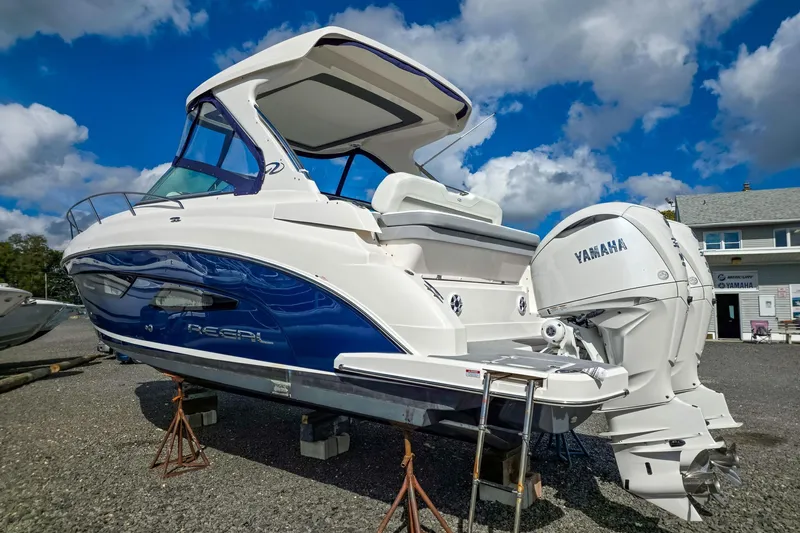 Yacht Photos Pics 2026 Regal 33 XO boat with Yamaha engines, displayed outdoors under a blue sky.