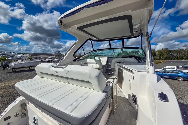  Yacht Photos Pics 2026 Regal 33 XO boat with luxurious seating and modern design under a blue sky.