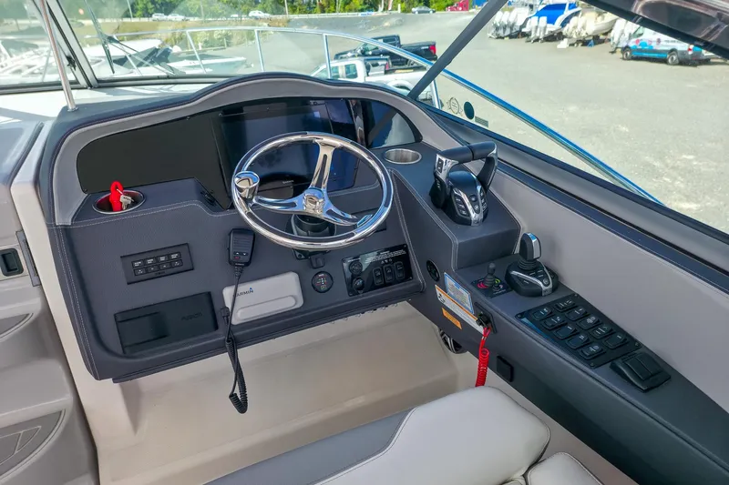  Yacht Photos Pics Helm of 2026 Regal 33 XO boat with modern controls and steering wheel.