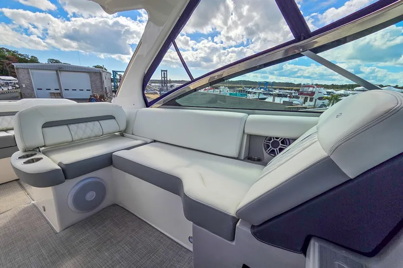  Yacht Photos Pics 2026 Regal 33 XO boat interior with luxurious seating and scenic marina view.