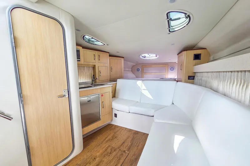  Yacht Photos Pics Luxurious interior of 2026 Regal 33 XO yacht with modern kitchen and seating area.