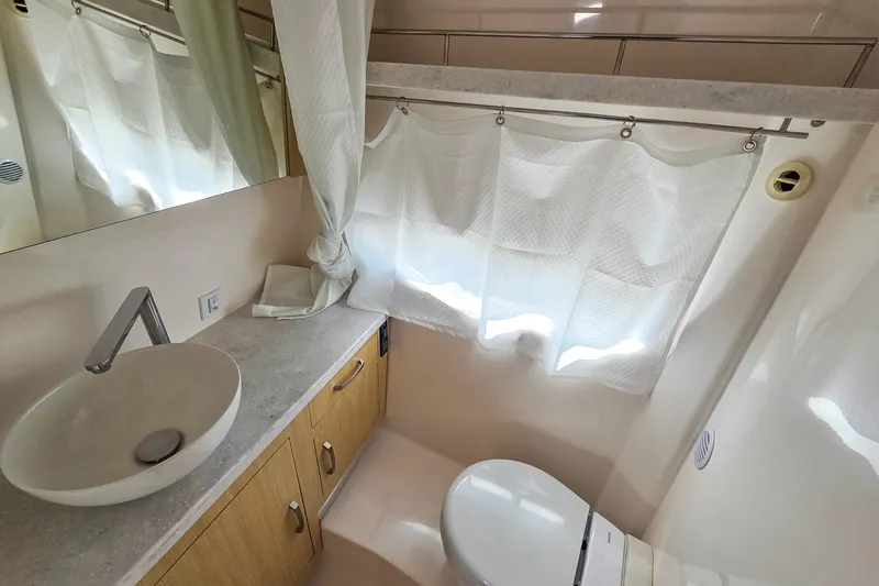  Yacht Photos Pics Modern bathroom interior of 2026 Regal 33 XO yacht with sink and toilet.
