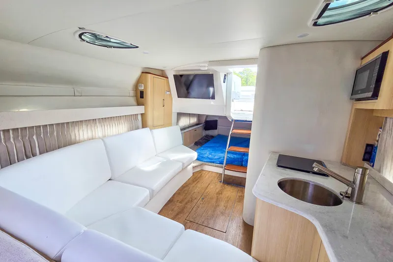  Yacht Photos Pics Luxurious interior of 2026 Regal 33 XO yacht with modern amenities and white seating.