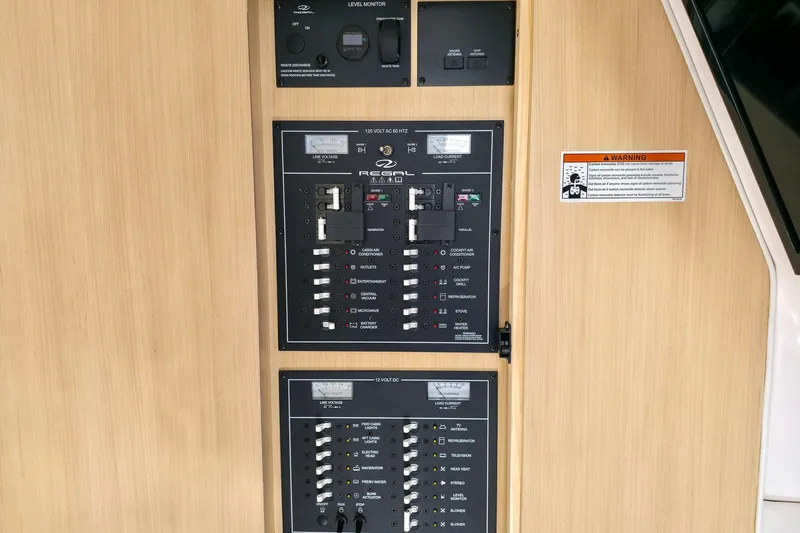  Yacht Photos Pics Electrical control panel of 2026 Regal 33 XO boat, featuring switches and warning label.