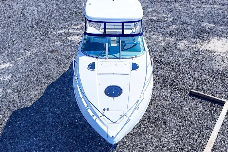  Yacht Photos Pics Aerial view of 2026 Regal 33 XO boat on gravel surface.
