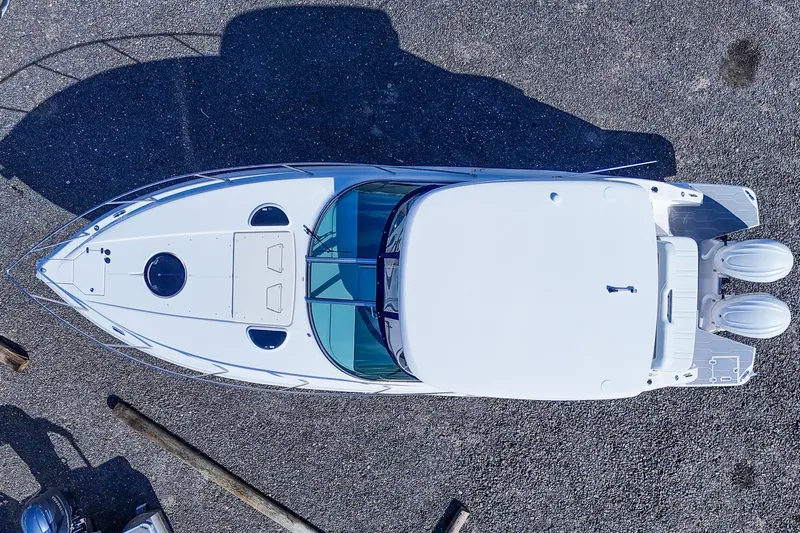  Yacht Photos Pics Overhead view of 2026 Regal 33 XO boat on gravel surface.