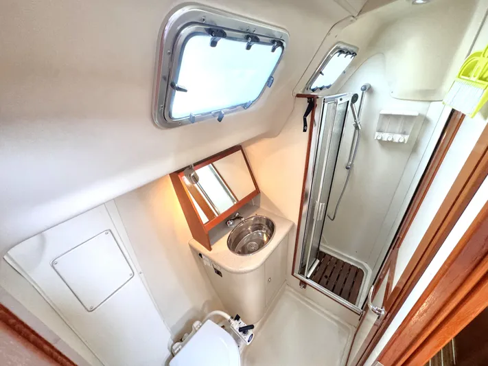 Stormcat Yacht Photos Pics Bathroom interior of 2006 Hunter 41 Deck Salon yacht with shower and sink.