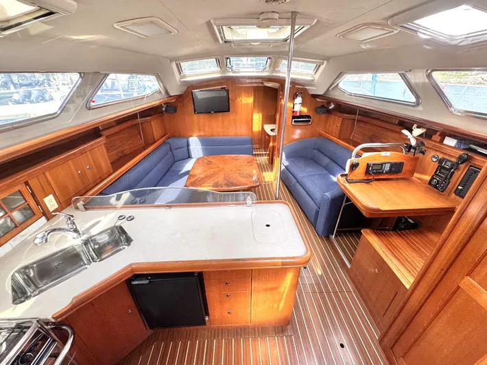 Stormcat Yacht Photos Pics Interior of 2006 Hunter 41 Deck Salon yacht with wood finish and seating area.