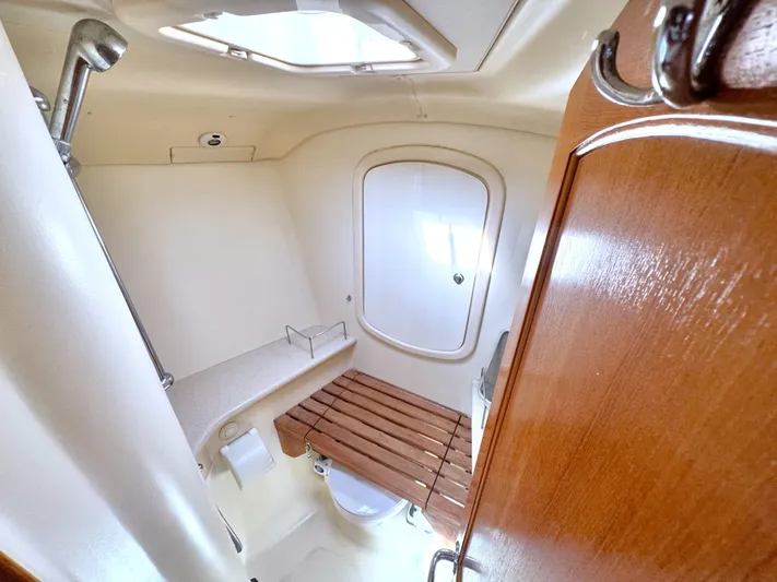 Stormcat Yacht Photos Pics Bathroom interior of 2006 Hunter 41 Deck Salon yacht, featuring shower and wooden seat.