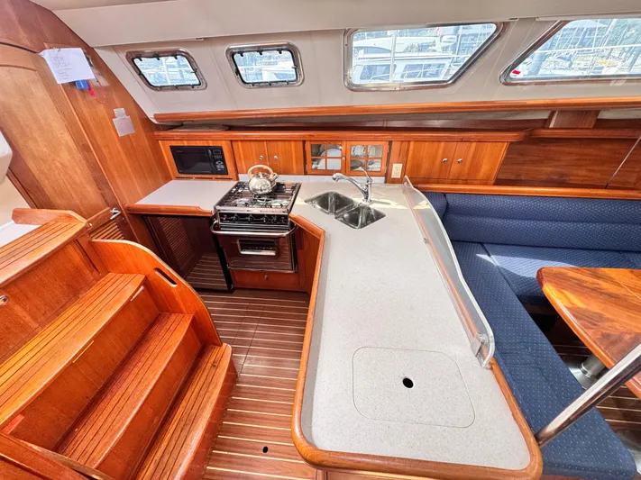 Stormcat Yacht Photos Pics Interior of 2006 Hunter 41 Deck Salon yacht with kitchen and seating area.