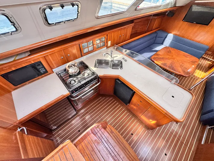 Stormcat Yacht Photos Pics Interior of 2006 Hunter 41 Deck Salon yacht with kitchen and seating area.