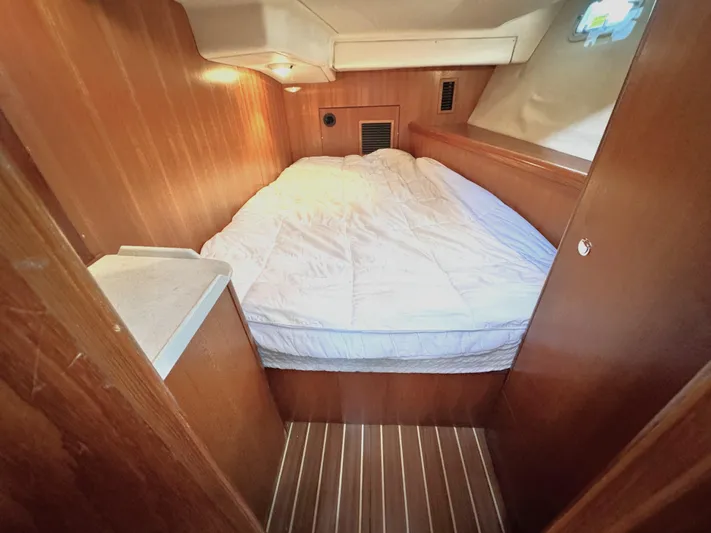 Stormcat Yacht Photos Pics Cozy cabin interior of 2006 Hunter 41 Deck Salon with wooden paneling and bed.