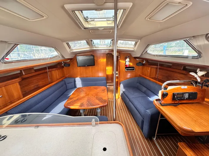 Stormcat Yacht Photos Pics Interior of 2006 Hunter 41 Deck Salon with wood finish and blue seating.