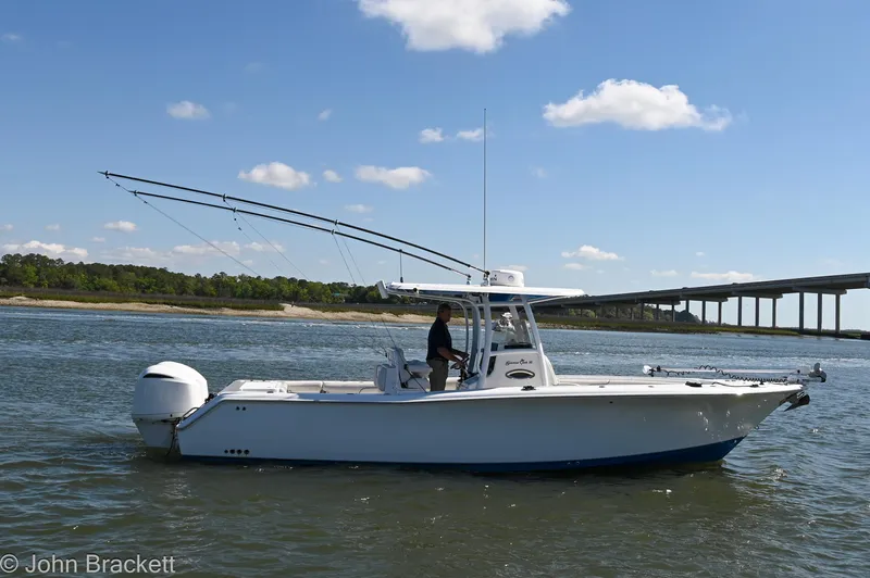 Sea Level Yacht Photos Pics 2014 Sea Hunt Gamefish 30 boat on water, bridge in background, clear sky.