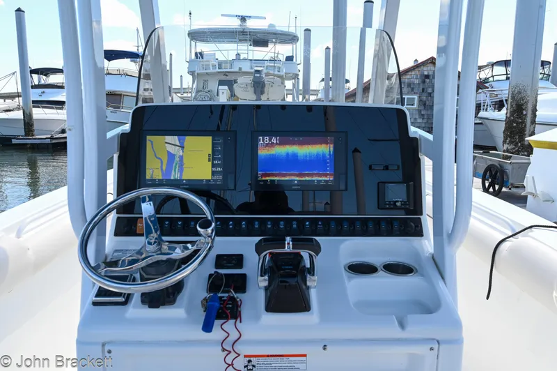 Sea Level Yacht Photos Pics 2014 Sea Hunt Gamefish 30 boat dashboard with navigation and control systems at a marina.