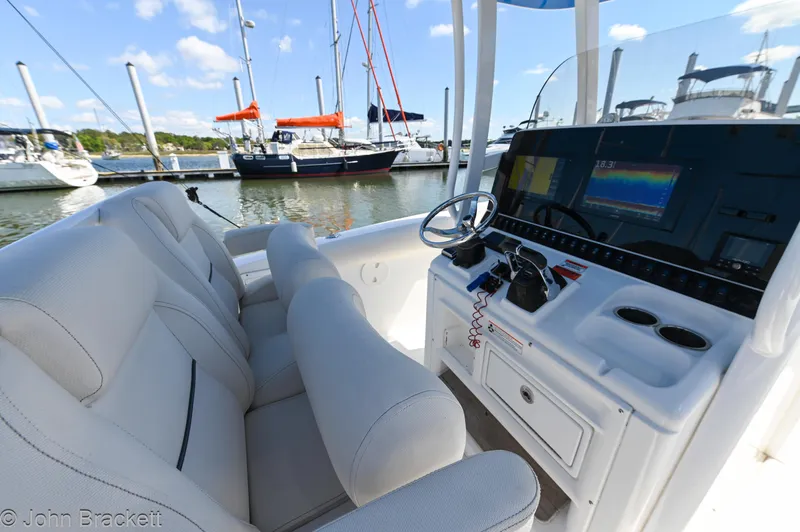 Sea Level Yacht Photos Pics 2014 Sea Hunt Gamefish 30 boat interior with helm, seats, and marina view.
