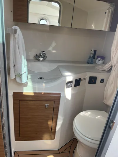  Yacht Photos Pics 2016 Cruisers Yachts 338SS bathroom with sink, mirror, and toilet.