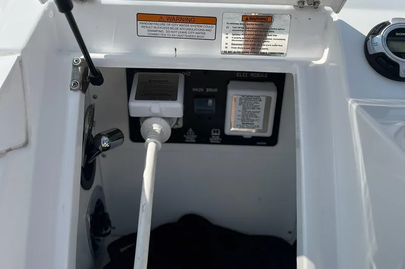  Yacht Photos Pics 2016 Cruisers Yachts 338SS electrical panel with warning labels and power connections.