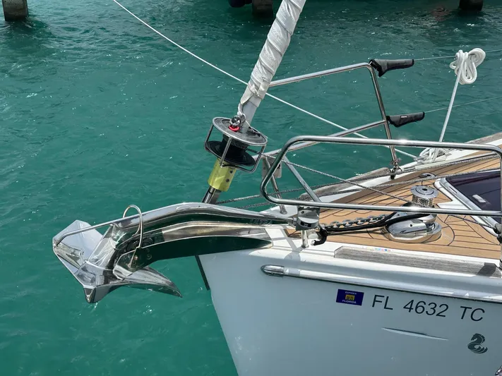  Yacht Photos Pics Beneteau Oceanis 50 sailboat bow with anchor, 2014 model, in turquoise water.