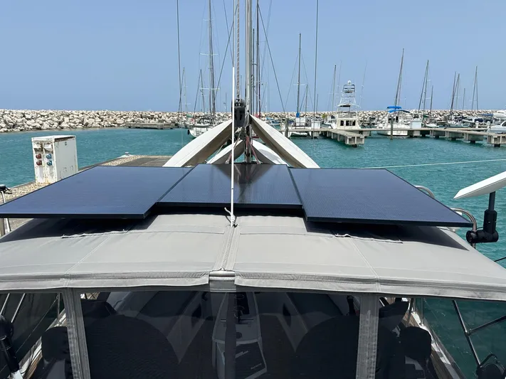  Yacht Photos Pics Beneteau Oceanis 50 sailboat with solar panels, docked in a marina, 2014 model.