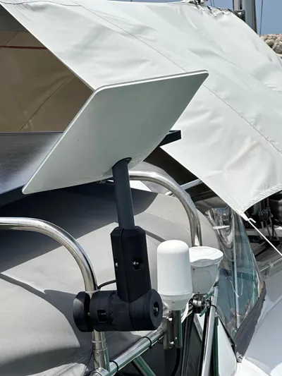  Yacht Photos Pics Satellite dish mounted on a 2014 Beneteau Oceanis 50 sailboat, under a white canopy.