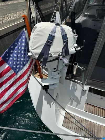  Yacht Photos Pics 2014 Beneteau Oceanis 50 sailboat with American flag and covered outboard motor.
