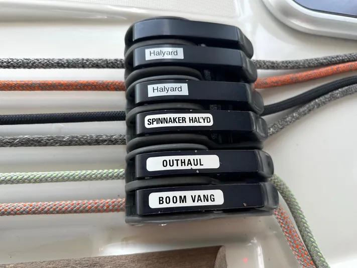  Yacht Photos Pics Sailing controls on a 2014 Beneteau Oceanis 50, labeled halyards, spinnaker, outhaul, boom vang.