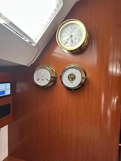  Yacht Photos Pics Interior of 2014 Beneteau Oceanis 50 yacht with brass instruments on wooden panel.