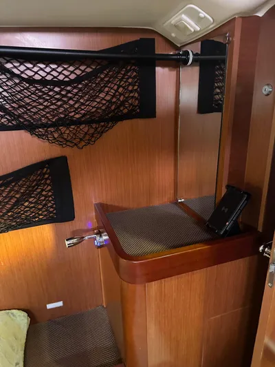  Yacht Photos Pics Interior of 2014 Beneteau Oceanis 50 sailboat with wooden finish and storage nets.