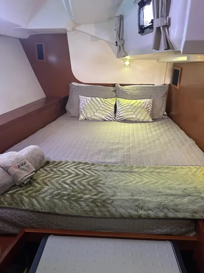  Yacht Photos Pics Cozy cabin interior of 2014 Beneteau Oceanis 50 yacht with neatly arranged bedding.