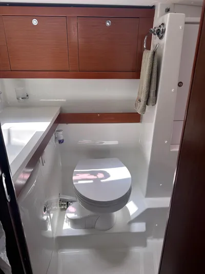  Yacht Photos Pics Bathroom interior of 2014 Beneteau Oceanis 50 yacht, featuring modern fixtures and wooden cabinetry.